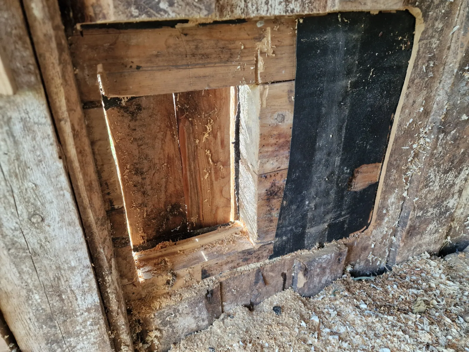 The opening cut halfway through the old barn wall, seen from the inside.