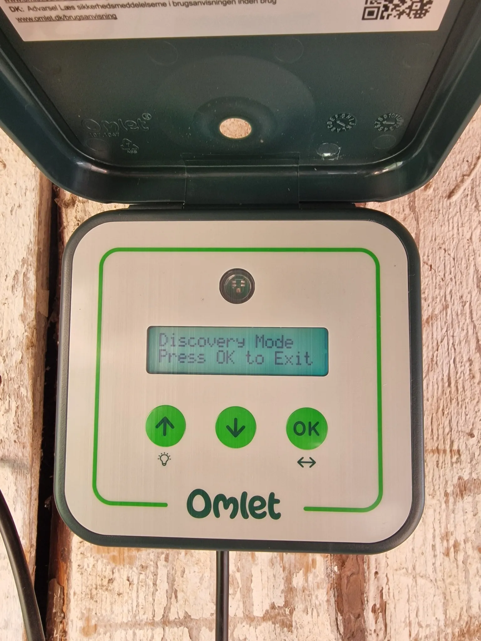 Omlet Smart Autodoor control panel with a display and up, down and OK buttons.