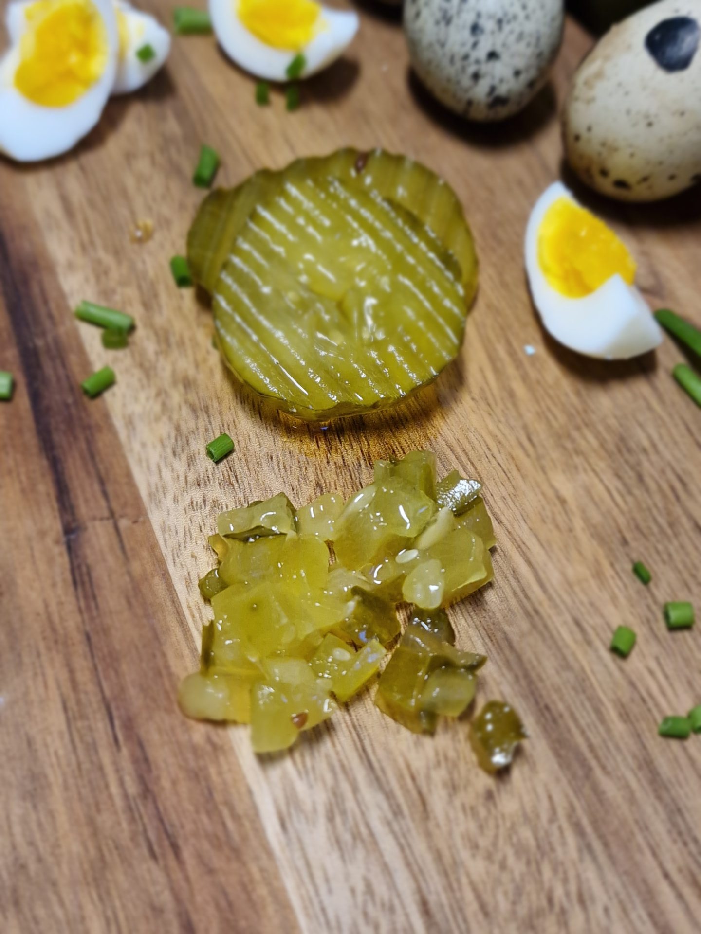 Finely chopped pickled cucumber on a cutting board