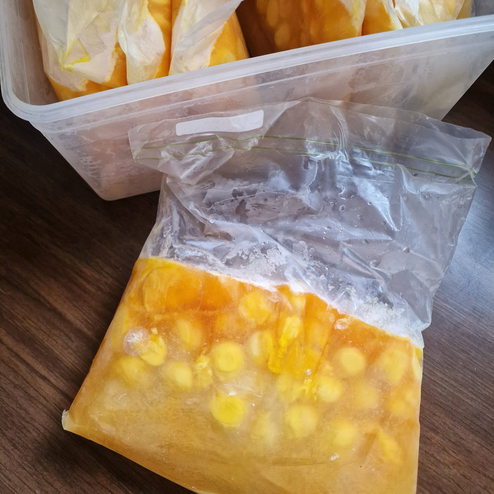 A bag of frozen quail egg mixture labelled with the date and quantity